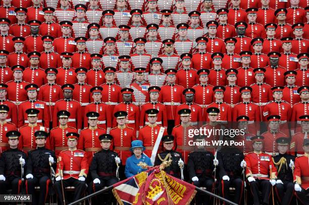 Queen Elizabeth II poses for an official photograph with the Grenadier Guards in Wellington Barracks after presenting the regiment with their new...