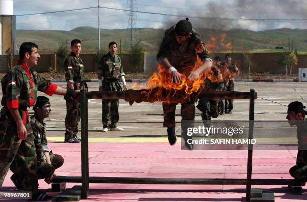 Kurdish Peshmerga soldiers demonstrate their skills during their graduation ceremony in the northern Kurdish city of Arbil on March 2, 2010. 1,200...