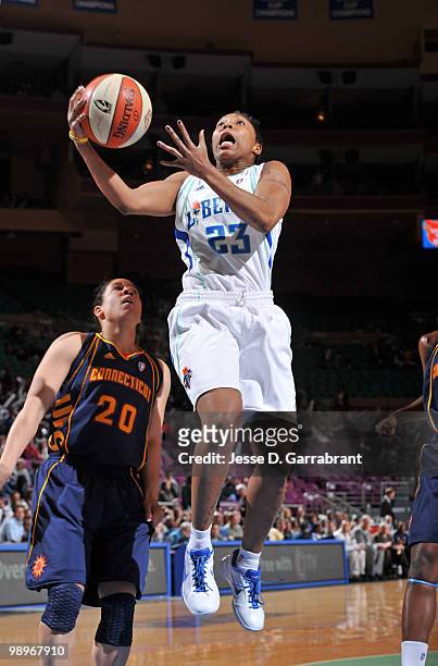 Cappie Pondexter of the New York Liberty shoots the basketball against Kara Lawson of the Connecticut Sun during the preseason WNBA game on May 11,...