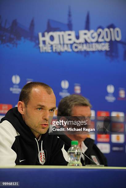 Danny Murphy answers questions while head coach Roy Hodgson looks on during the Fulham press conference ahead of the UEFA Europa League final match...