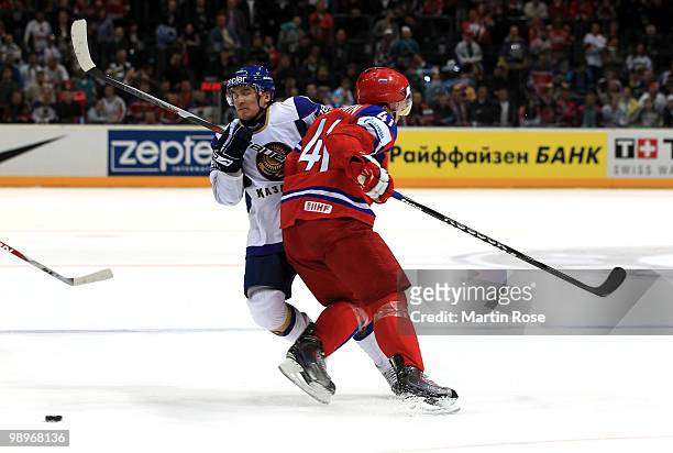 Nikolai Kulemin of Russia tackles Talgat Zhailauov of Kazakhstan during the IIHF World Championship group A match between Russia and Kazakhstan at...