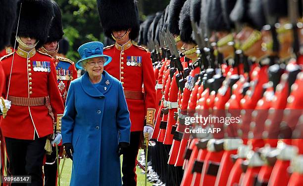 British Queen Elizabeth , and her husband Prince Philip , inspect The 1st Battalion Grenadier Guards before presenting them with their new colours at...
