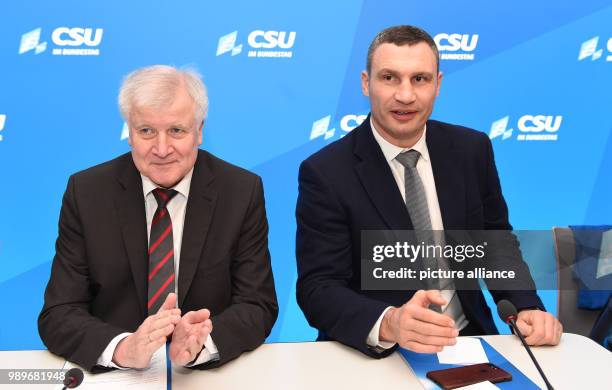 Bavarian Premier and head of the German Christian Social Union party, Horst Seehofer sits next to Kiev's mayor and chairman of Ukrainian government...