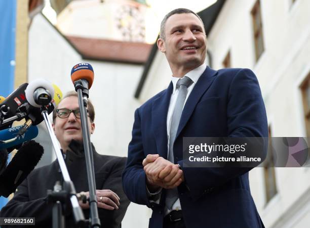 German Minister of Transport Alexander Dobrindt stands behind former Ukrainian boxing pro, mayor of Kiev and chairman of Ukrainian government party...