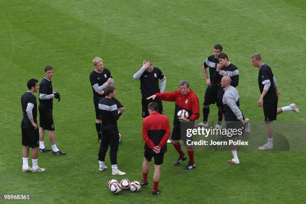 Head coach Roy Hodgson gives instructions to his players during the Fulham training session ahead of the UEFA Europa League final match against...