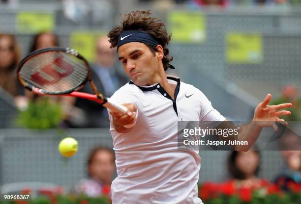 Roger Federer of Switzerland plays a ball to Bejamin Becker of Germany in their second round match during the Mutua Madrilena Madrid Open tennis...