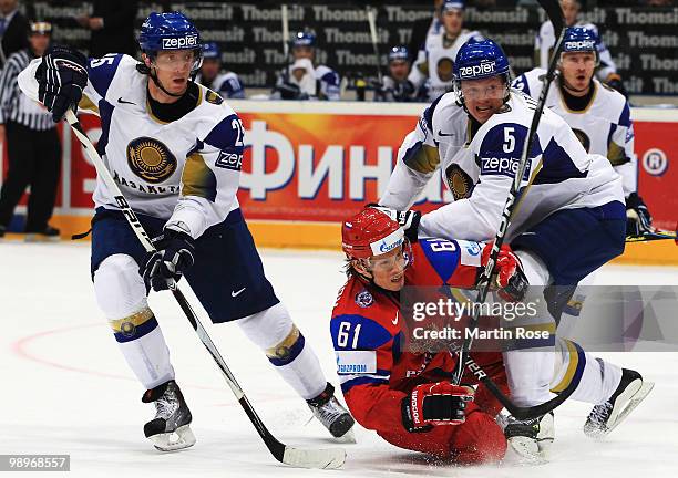 Maxim Afinogenov of Russia and Alexei Litvinenko of Kazakhstan battle for the puck during the IIHF World Championship group A match between Russia...