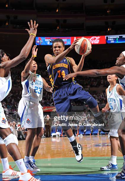 Tan White of the Connecticut Sun passes the basketball against Cappie Pondexter of the New York Liberty during the preseason WNBA game on May 11,...
