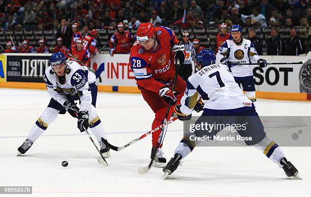 Alexander Semin of Russia is attacked by Andrei Gavrilin and Maxim Semenov of Kazakhstan during the IIHF World Championship group A match between...