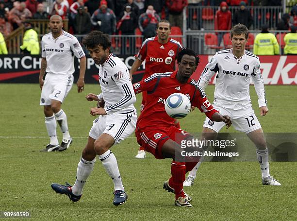Amadou Sanyang of Toronto FC gets pushed by Baggio Husidic of the Chicago Fire during a MLS game at BMO Field May 8, 2010 in Toronto, Ontario, Canada.