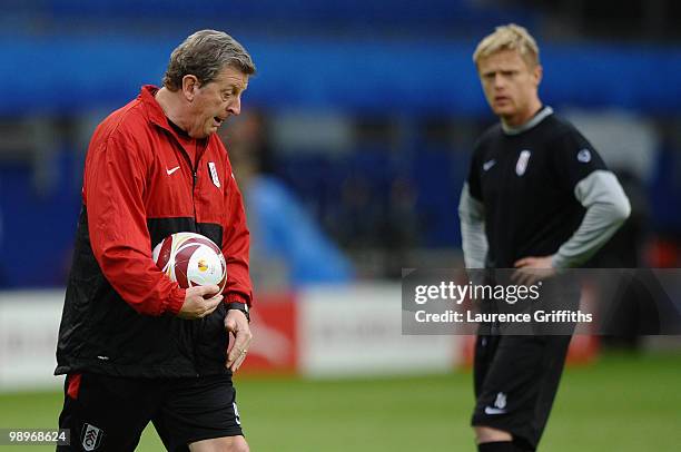 Head coach Roy Hodgson issues instructions as Damien Duff looks on during the Fulham training session ahead of the UEFA Europa League final match...