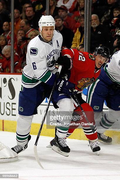 Tomas Kopecky of the Chicago Blackhawks and Sami Salo of the Vancouver Canucks battle behind the net in Game Five of the Western Conference...