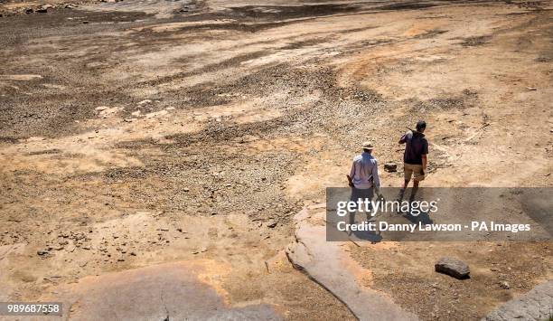 National Trust volunteers on the dry banks of March Haigh reservoir near Kirklees in West Yorkshire. Parts of England could be lashed by...