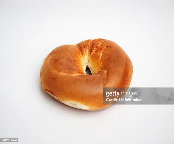 freshly made bagel against white background - liz white stock pictures, royalty-free photos & images