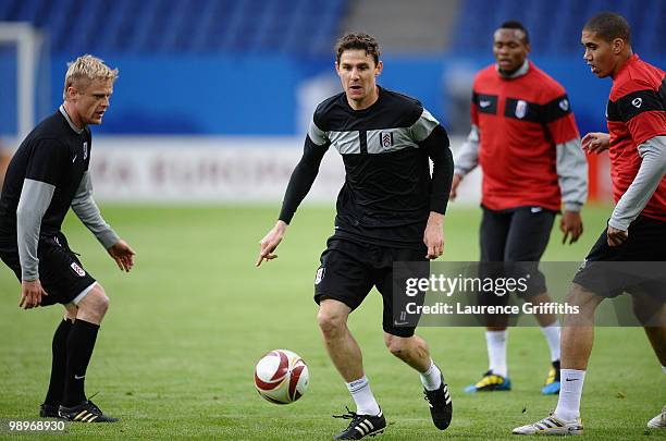 Zoltan Gera is challenged by his team mates Damien Duff and Chris Smalling during the Fulham training session ahead of the UEFA Europa League final...
