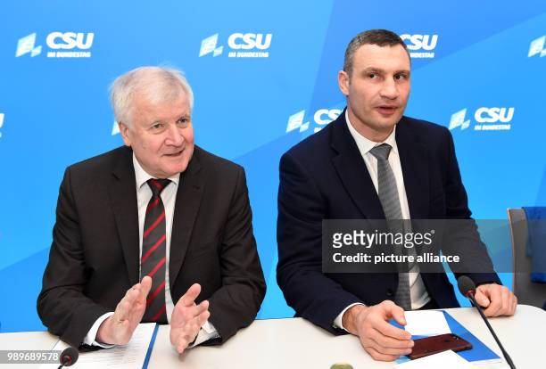 Bavarian Premier and head of the German Christian Social Union party, Horst Seehofer sits next to Kiev's mayor and chairman of Ukrainian government...