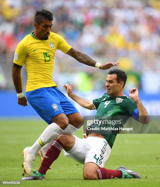 Rafael Marquez of Mexico tackles Paulinho of Brazil during the 2018 FIFA World Cup Russia Round of 16 match between Brazil and Mexico at Samara Arena...