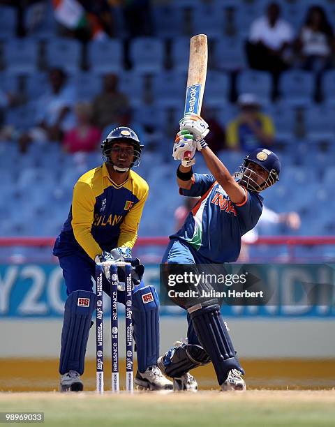 Kumar Sangakkara looks on as Gautam Gambhir hits out during the ICC Super Eight match between India and Sri Lanka played at the Beausejour Cricket...