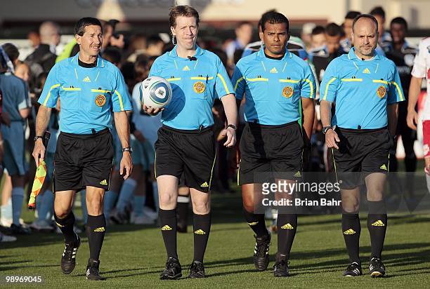 Craig Lowry, referee Andrew Chapin, Paul Scott, and Yader Reyes walk on to the pitch for a match between the San Jose Earthquakes and the New York...