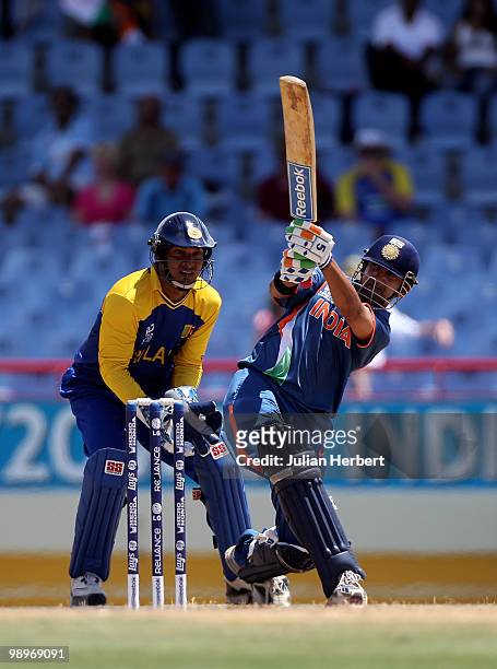 Kumar Sangakkara looks on as Gautam Gambhir hits out during the ICC Super Eight match between India and Sri Lanka played at the Beausejour Cricket...