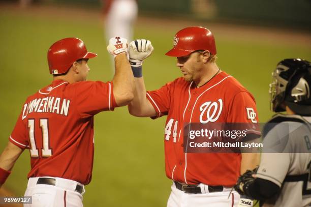 Ryan ZImmerman of the Washington Nationals celebrates a home run with Adam Dunn during a baseball game against the Florida Marlins on May 7, 2010 at...