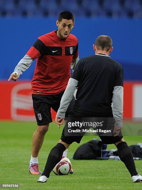 Clint Dempsey is challenged by a team mate during the Fulham training session ahead of the UEFA Europa League final match against Atletico Madrid at...