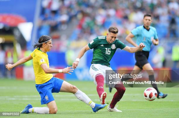 Filipe Luis of Brazil competes with Hector Herrera of Mexico during the 2018 FIFA World Cup Russia Round of 16 match between Brazil and Mexico at...