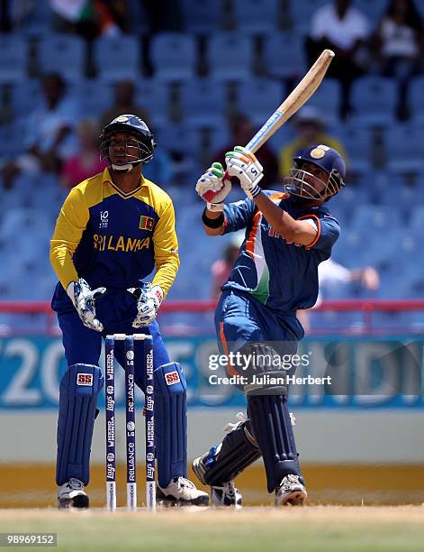 Kumar Sangakkara looks on as Gautam Gambhir hits out during the ICC Super Eight match between India and Sri Lanka played at the Beausejour Cricket...