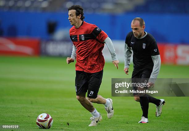 Simon Davies is chased by Danny Murphy during the Fulham training session ahead of the UEFA Europa League final match against Atletico Madrid at HSH...