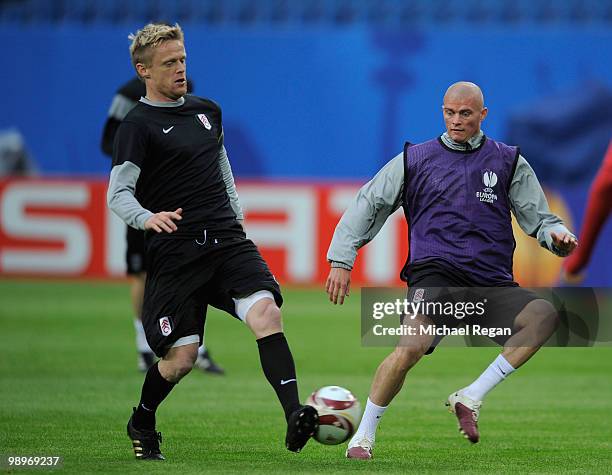 Paul Konchesky is challenged by Damien Duff during the Fulham training session ahead of the UEFA Europa League final match against Atletico Madrid at...