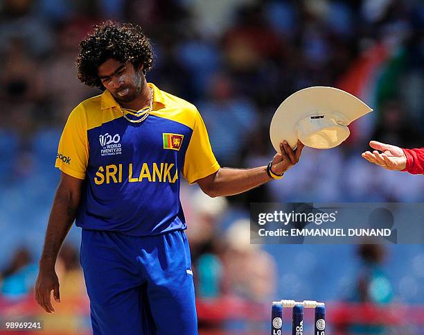 Sri Lankan bowler Lasith Malinga collects his hat after bowling an over during the ICC World Twenty20 Super Eight match between India and Sri Lanka...