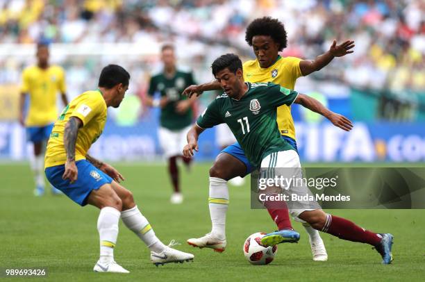 Carlos Vela of Mexico is challenged by Willian and Fagner of Brazil during the 2018 FIFA World Cup Russia Round of 16 match between Brazil and Mexico...