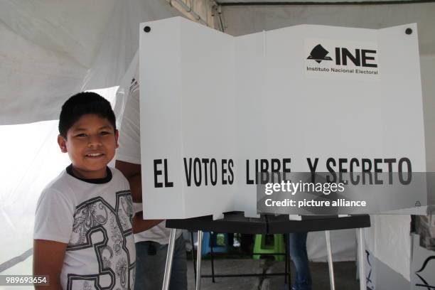 July 2018, Mexico, Mexico City: A child smiling at a polling station. Mexicans are electing a new president and the occupants of further political...