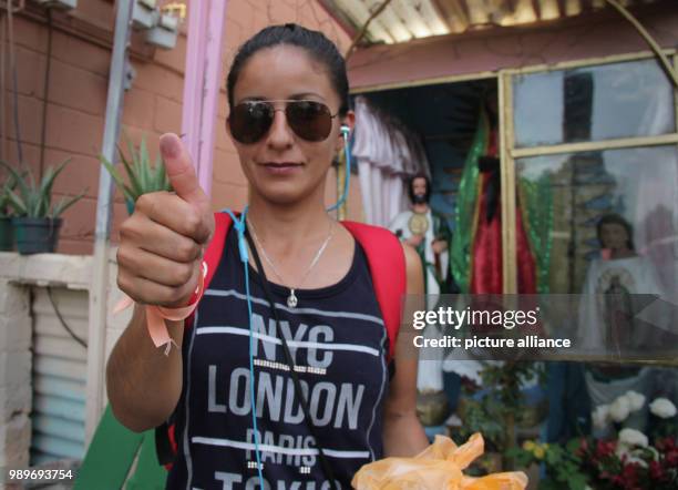 July 2018, Mexico, Mexico City: A woman showing her thumb after casting her vote. Mexicans are electing a new president and the occupants of further...