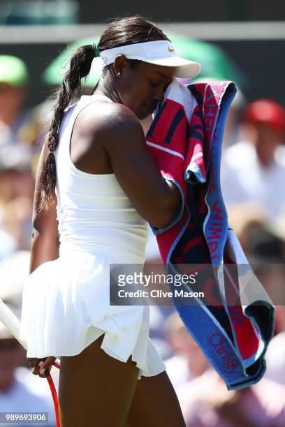 Sloane Stephens of the United States wipes her face during her Ladies' Singles first round match against Donna Vekic of Croatia on day one of the...