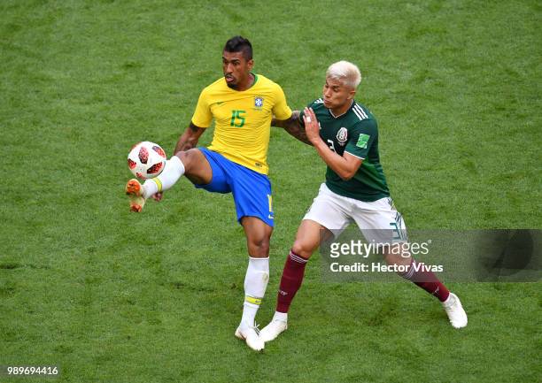 Paulinho of Brazil is challenged by Carlos Salcedo of Mexico during the 2018 FIFA World Cup Russia Round of 16 match between Brazil and Mexico at...