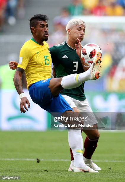 Paulinho of Brazil challenge for the ball with Carlos Salcedo of Mexico during the 2018 FIFA World Cup Russia Round of 16 match between Brazil and...