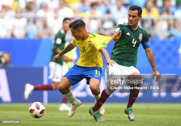 Philippe Coutinho of Brazil battles for possession with Rafael Marquez of Mexico during the 2018 FIFA World Cup Russia Round of 16 match between...