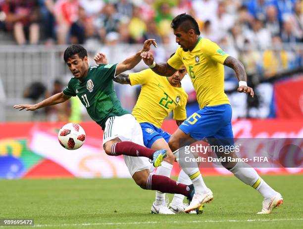 Carlos Vela of Mexico is challenged by Paulinho of Brazil and Fagner of Brazil during the 2018 FIFA World Cup Russia Round of 16 match between Brazil...