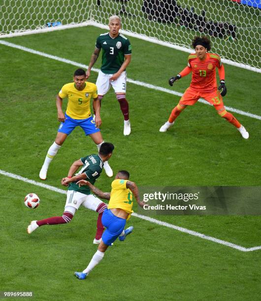 Gabriel Jesus of Brazil shoots past Jesus Gallardo of Mexico during the 2018 FIFA World Cup Russia Round of 16 match between Brazil and Mexico at...