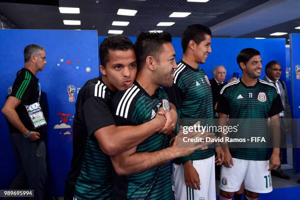 Giovani Dos Santos of Mexico hugs teammate Marco Fabian of Mexico in the tunnel prior to the 2018 FIFA World Cup Russia Round of 16 match between...