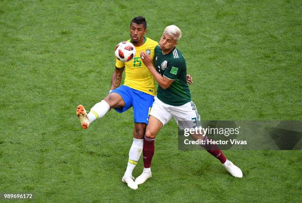 Paulinho of Brazil is challenged by Carlos Salcedo of Mexico during the 2018 FIFA World Cup Russia Round of 16 match between Brazil and Mexico at...