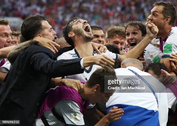 The Russia team celebrate with Aleksandr Erokhin of Russia during the 2018 FIFA World Cup Russia Round of 16 match between Spain and Russia at...