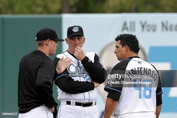 Pitcher Stephen Strasburg of the Syracuse Chiefs talks with pitching coach Greg Booker and catcher Carlos Maldonado prior to his AAA minor league...