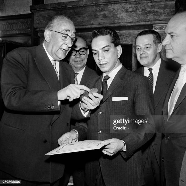Mexican actor Cantinflas reveives from town council Paris' President Julien Tardien the City of Paris medal on April 11, 1961 at Paris' city hall as...