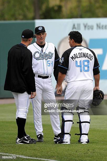 Pitcher Stephen Strasburg of the Syracuse Chiefs talks with pitching coach Greg Booker and catcher Carlos Maldonado prior to his AAA minor league...