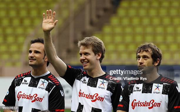 Vitantonio Liuzzi of Italy and Force India, Sebastian Vettel of Germany and Red Bull Racing and Jarno Trulli of Italy and Lotus are pictured ahead...