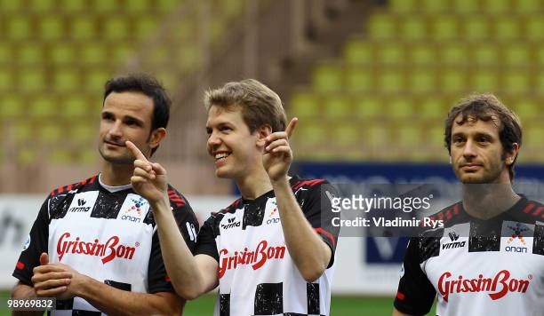 Vitantonio Liuzzi of Italy and Force India, Sebastian Vettel of Germany and Red Bull Racing and Jarno Trulli of Italy and Lotus are pictured ahead...