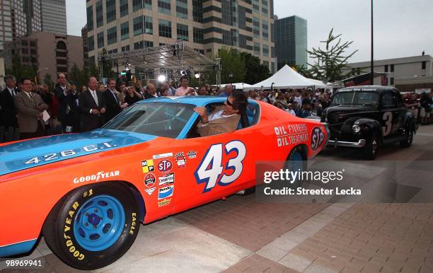 Richard Petty surprises fans as he gets out of his car to welcome the crowd to the NASCAR Hall of Fame Grand Opening at the NASCAR Hall of Fame on...