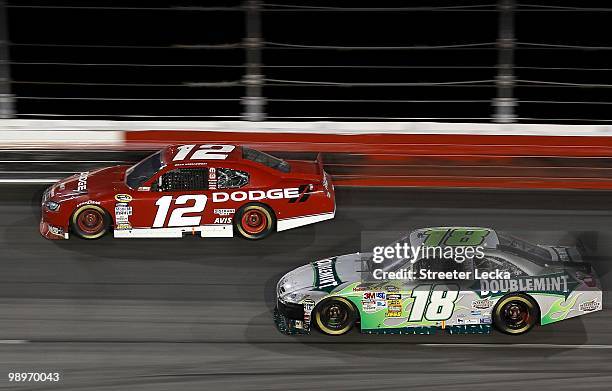 Brad Keselowski, driver of the Penske Dodge, leads Kyle Busch, driver of the Doublemint Toyota, during the NASCAR Sprint Cup series SHOWTIME Southern...